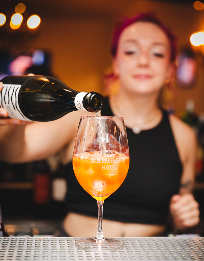 Women Pouring a Cocktail in Glassware